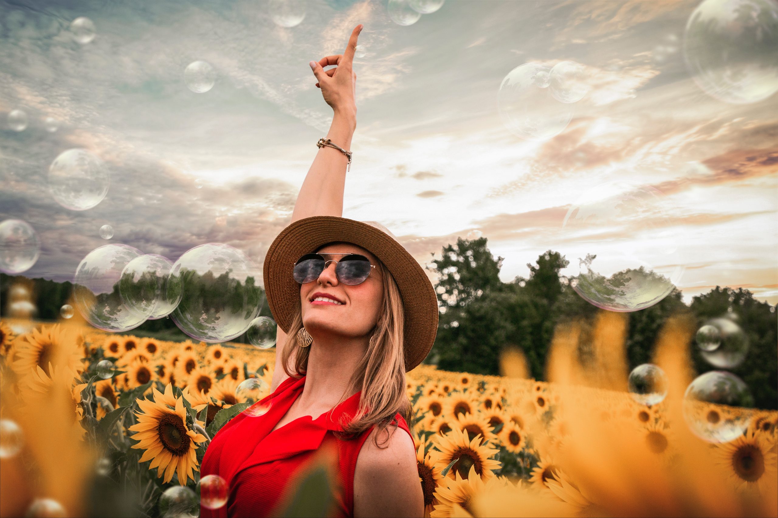 woman-surrounded-by-sunflowers-raising-h